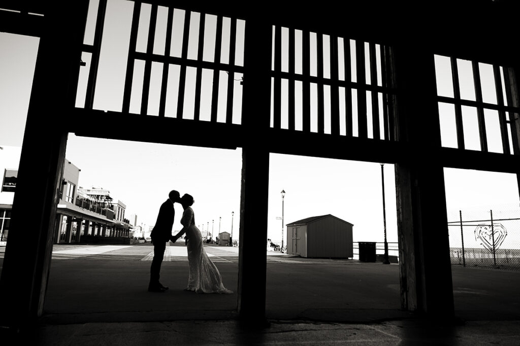 bride and groom kissing at Asbury Park Casino on their wedding day in Asbury Park.