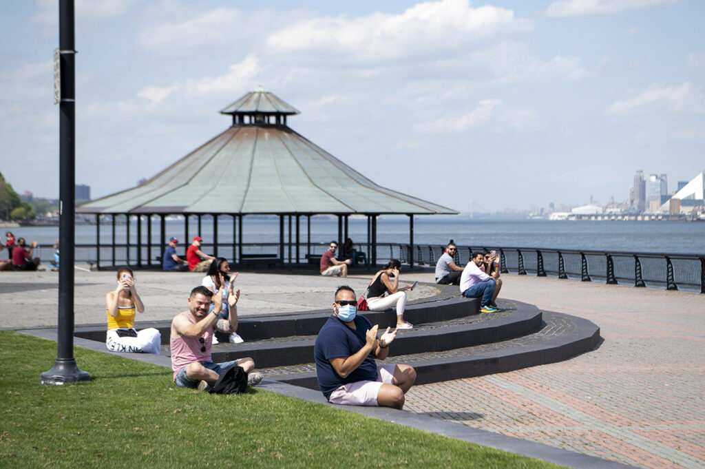 Crowds of strangers cheer for the newly married couple after their ceremony concludes on Pier A in Hoboken