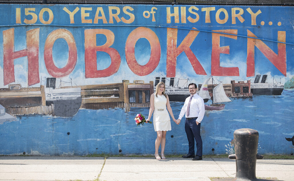 wedding couple in front of Hoboken Mural on their micro wedding day