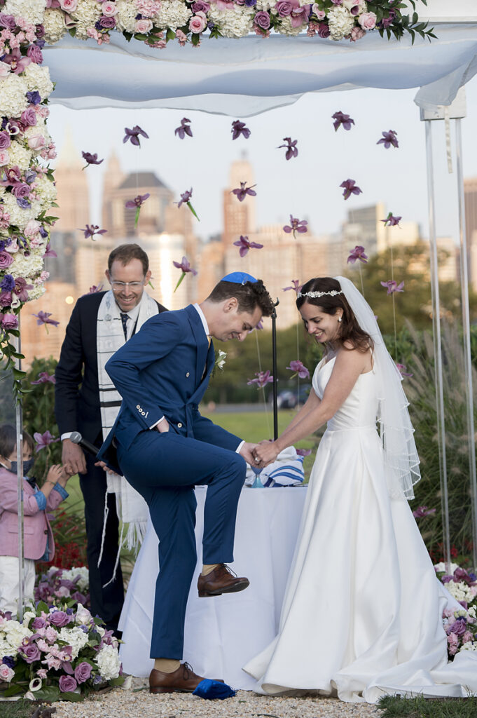 groom breaking the glass at the conclusion of a Jewish wedding ceremony at Liberty House in Jersey City