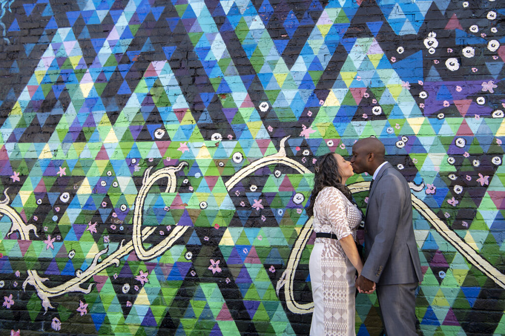 wedding couple in front of mural in Welling Court