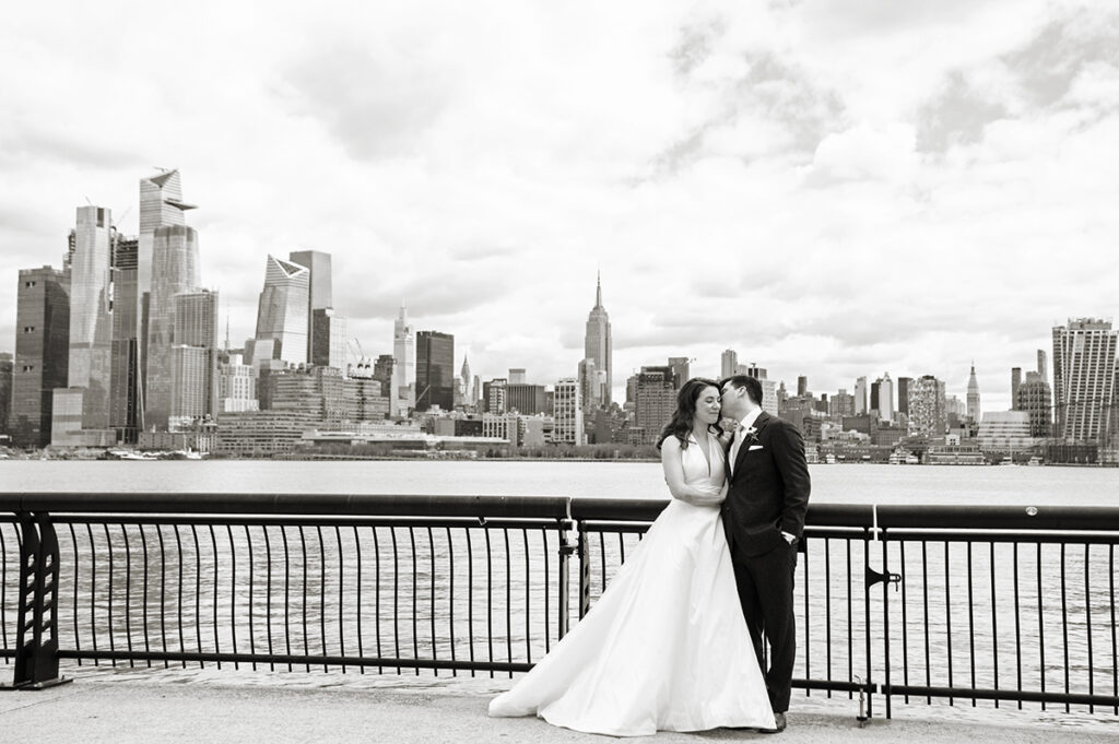 Bride and groom on their wedding day in Hoboken with NYC skyline 