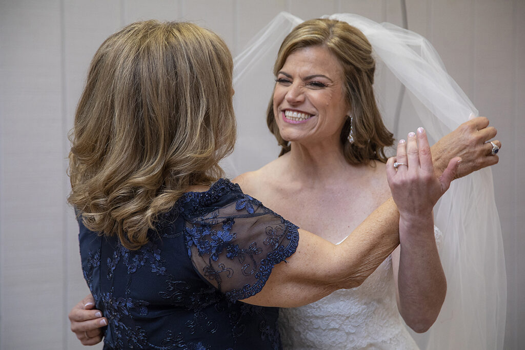 bride and her mom sharing a moment on wedding day at Windows on the Water at Frogbridge. LGBTQ wedding