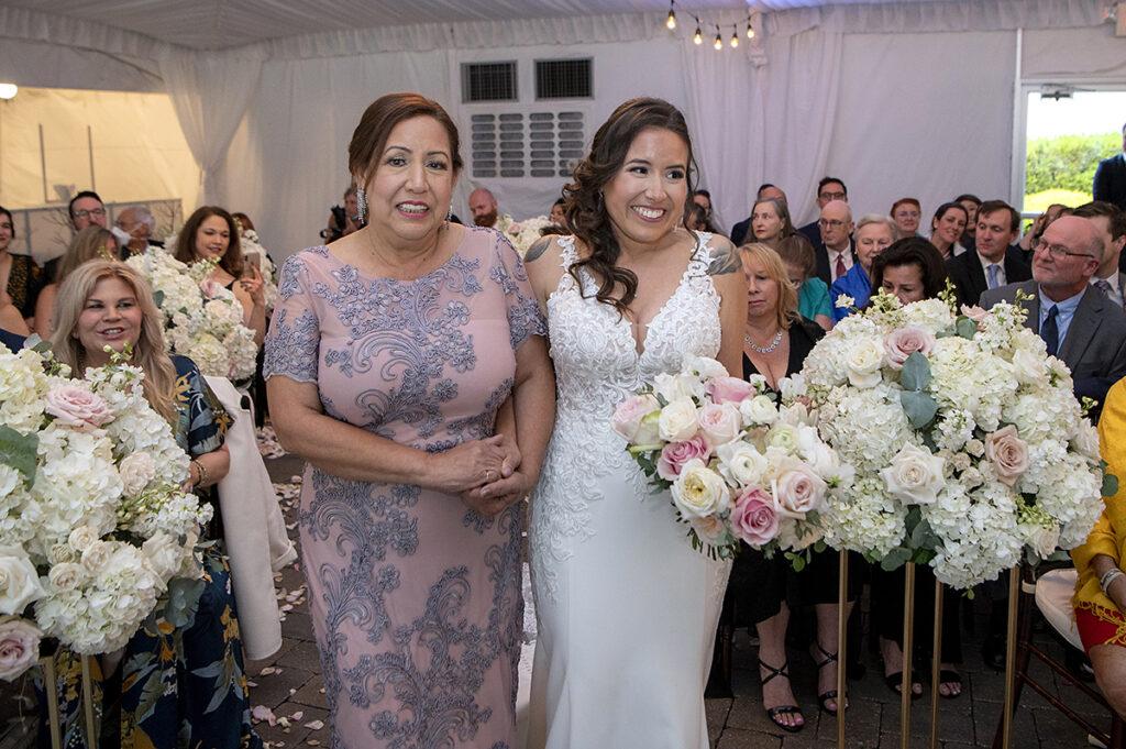 bride walks down the aisle on wedding day at Windows on the Water at Frogbridge. LGBTQ wedding