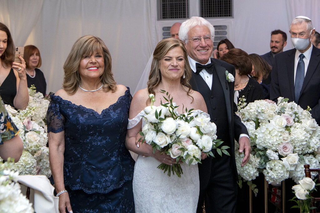 bride walks down the aisle on wedding day at Windows on the Water at Frogbridge. LGBTQ wedding