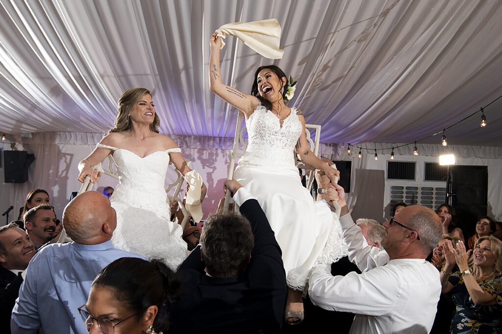 hora at wedding reception on wedding day at Windows on the Water at Frogbridge. LGBTQ wedding