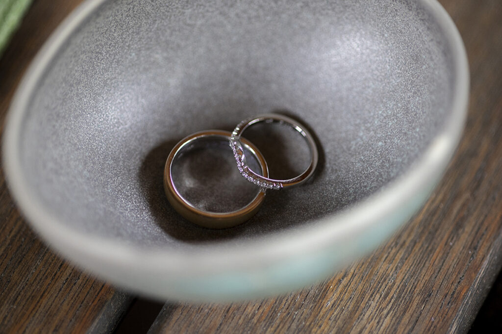 wedding rings in a bowl on wedding day at River House at Odette’s in New Hope.