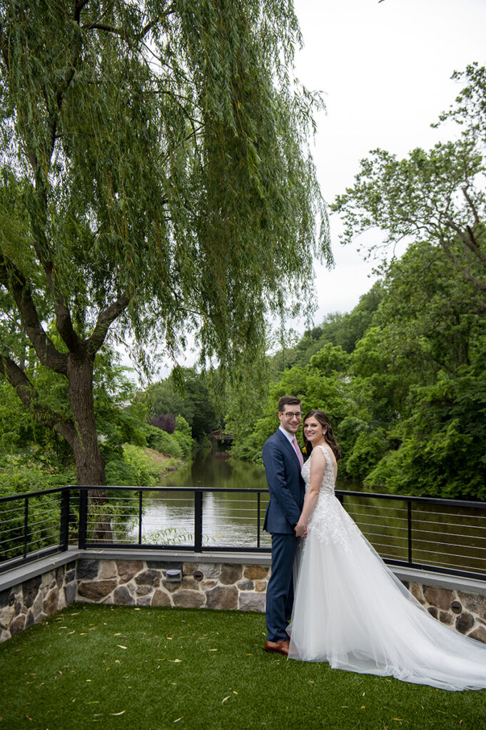 bride and groom on wedding day at River House at Odette’s in New Hope.