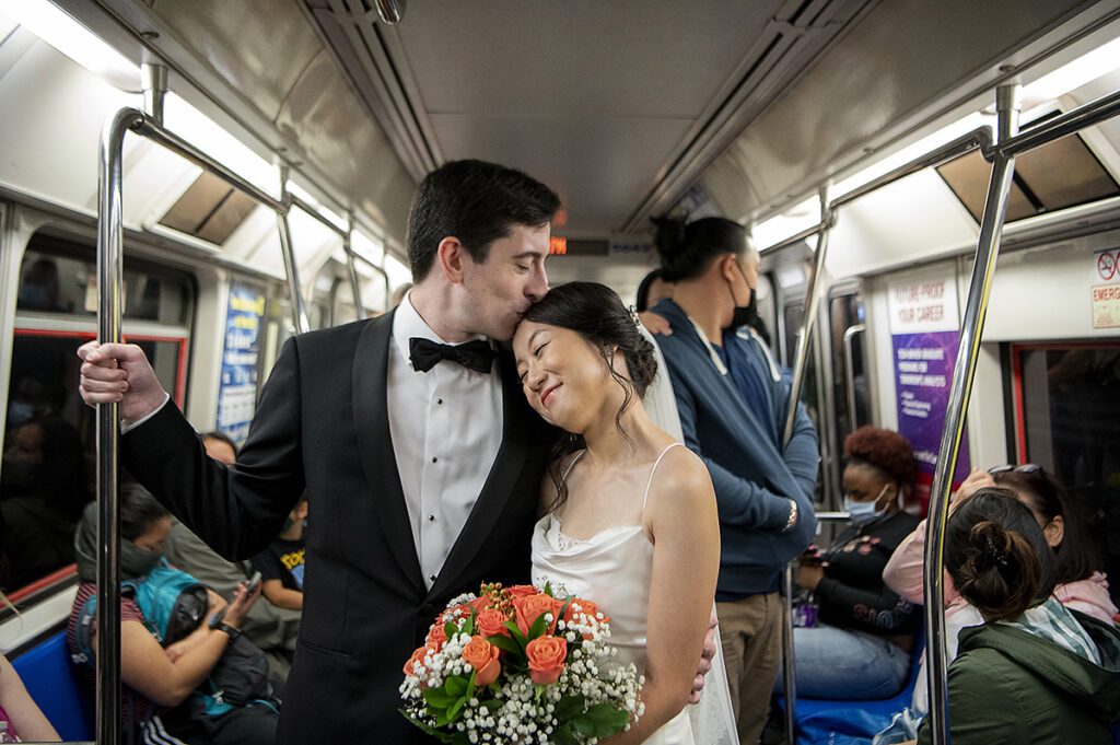 bride and groom on the PATH train on their way to their wedding in NYC