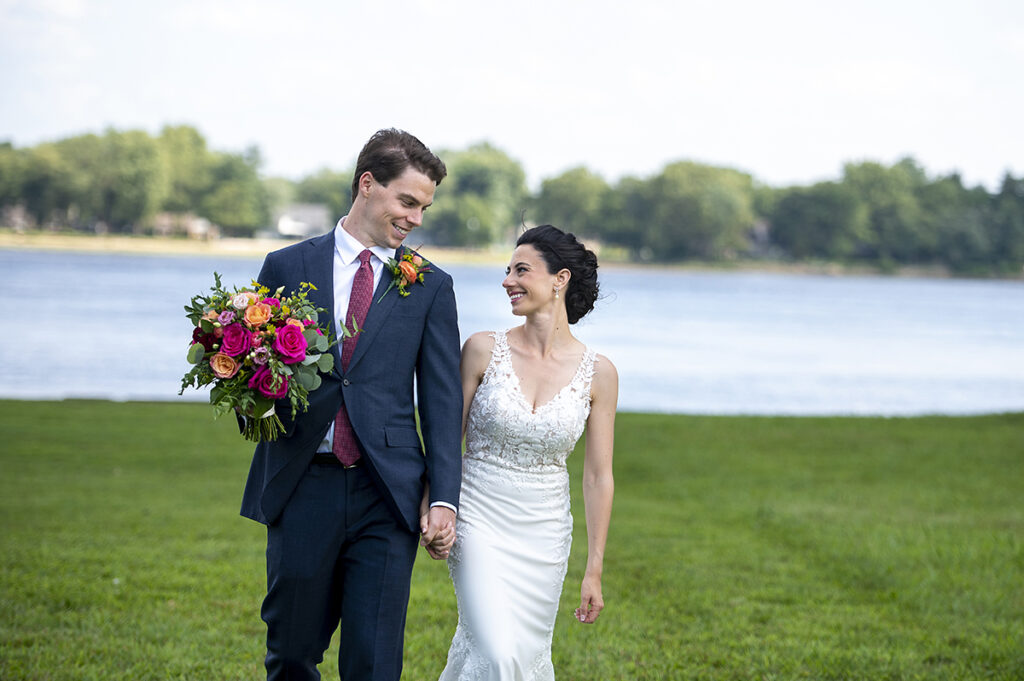 bride and groom along the river on their wedding day at Belle Voir Manor at Pen Ryn Estate