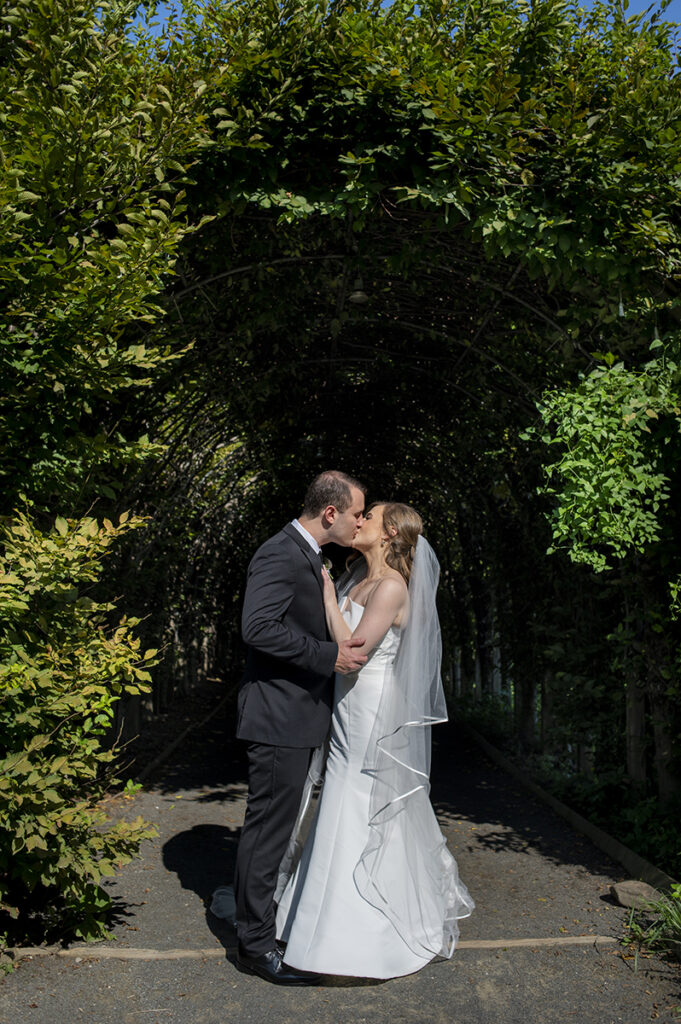 bride and groom on their wedding day at Celebrate at Snug Harbor botanical gardens