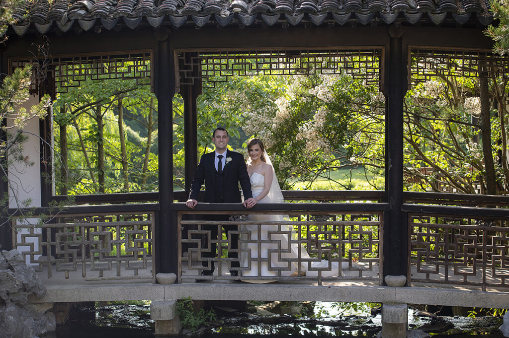 bride and groom on their wedding day at Celebrate at Snug Harbor botanical gardens