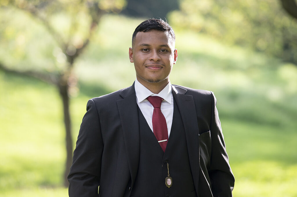 groom poses for portraits after their intimate Queens Botanical Garden wedding