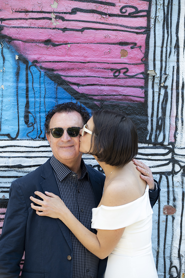 bride and groom with mural at Jersey City elopement