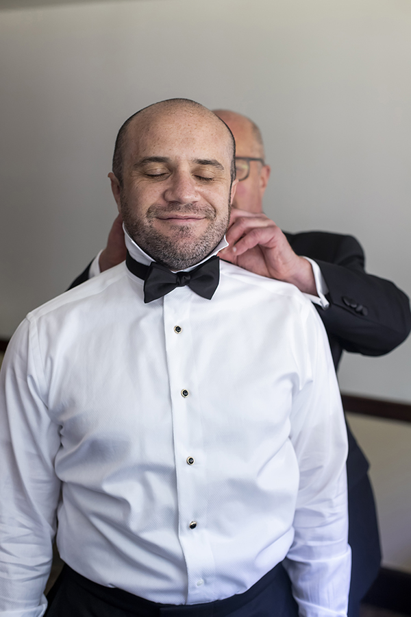 groom getting ready at summer wedding at Temple Emanu-El in Closter