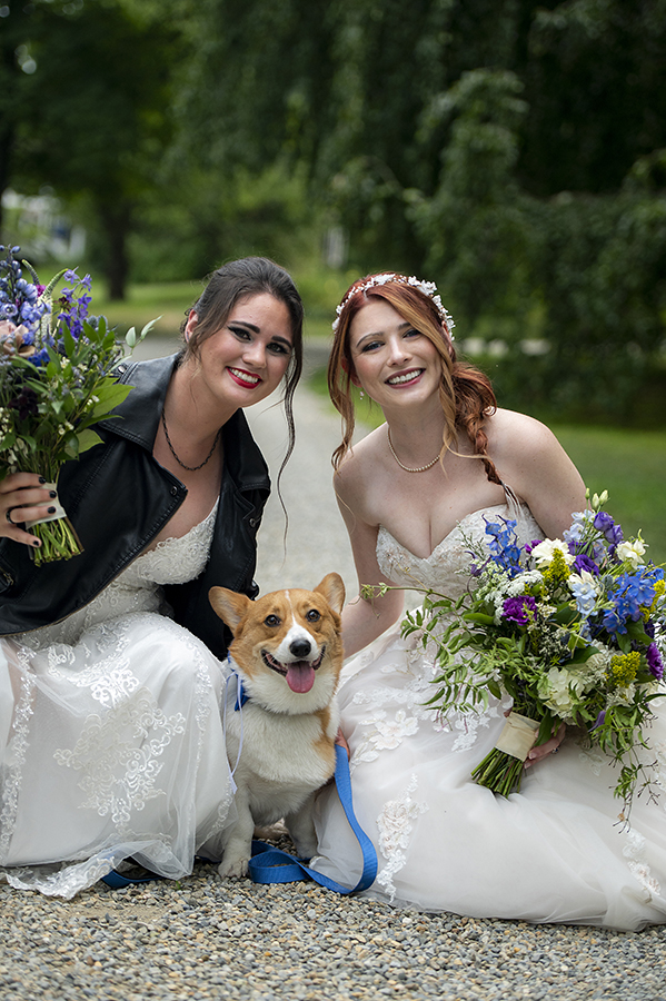 brides posing for portrait with their dog before their Crossed Keys Estate Wedding