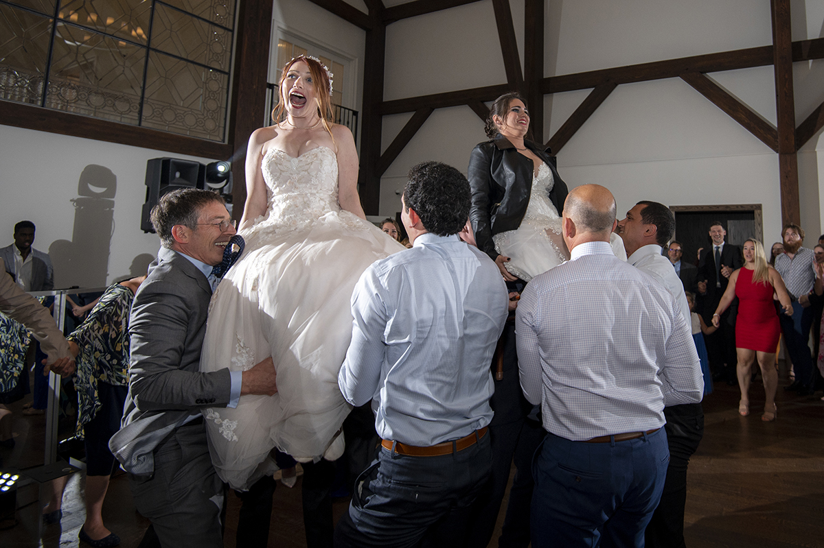brides chair lift hora at their reception at Crossed Keys Estate Wedding