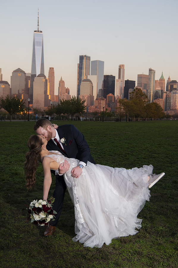 bride and groom with NYC skyline at Liberty House in Jersey City on their wedding day