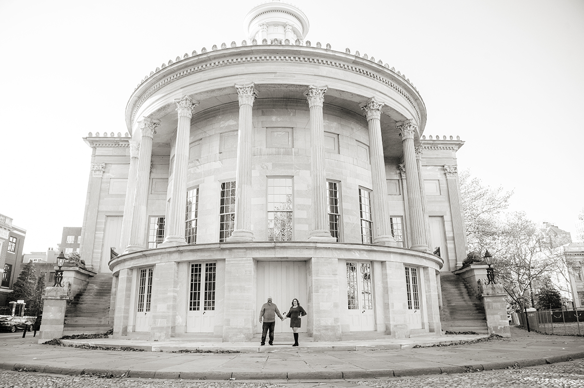 couple posing at Merchant Exchange Building in Philadelphia for their Old City Philly engagement session