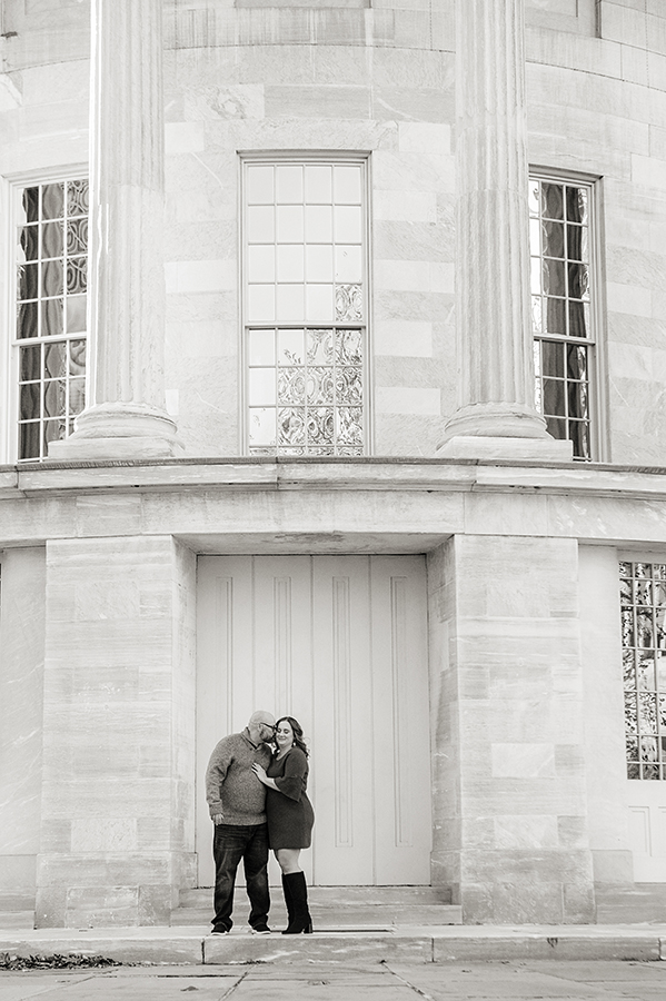 couple posing at Merchant Exchange Building in Philadelphia for their Old City Philly engagement session