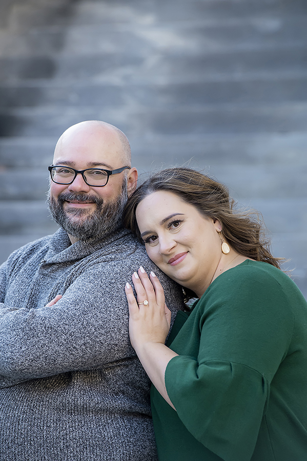 couple posing at Merchant Exchange Building in Philadelphia for their Old City Philly engagement session