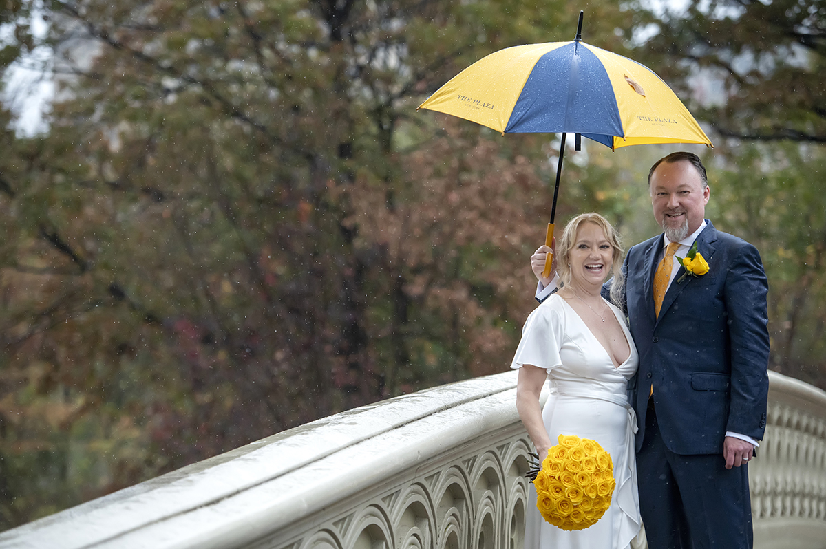 bride and groom in rain on their wedding day in Central Park, NYC