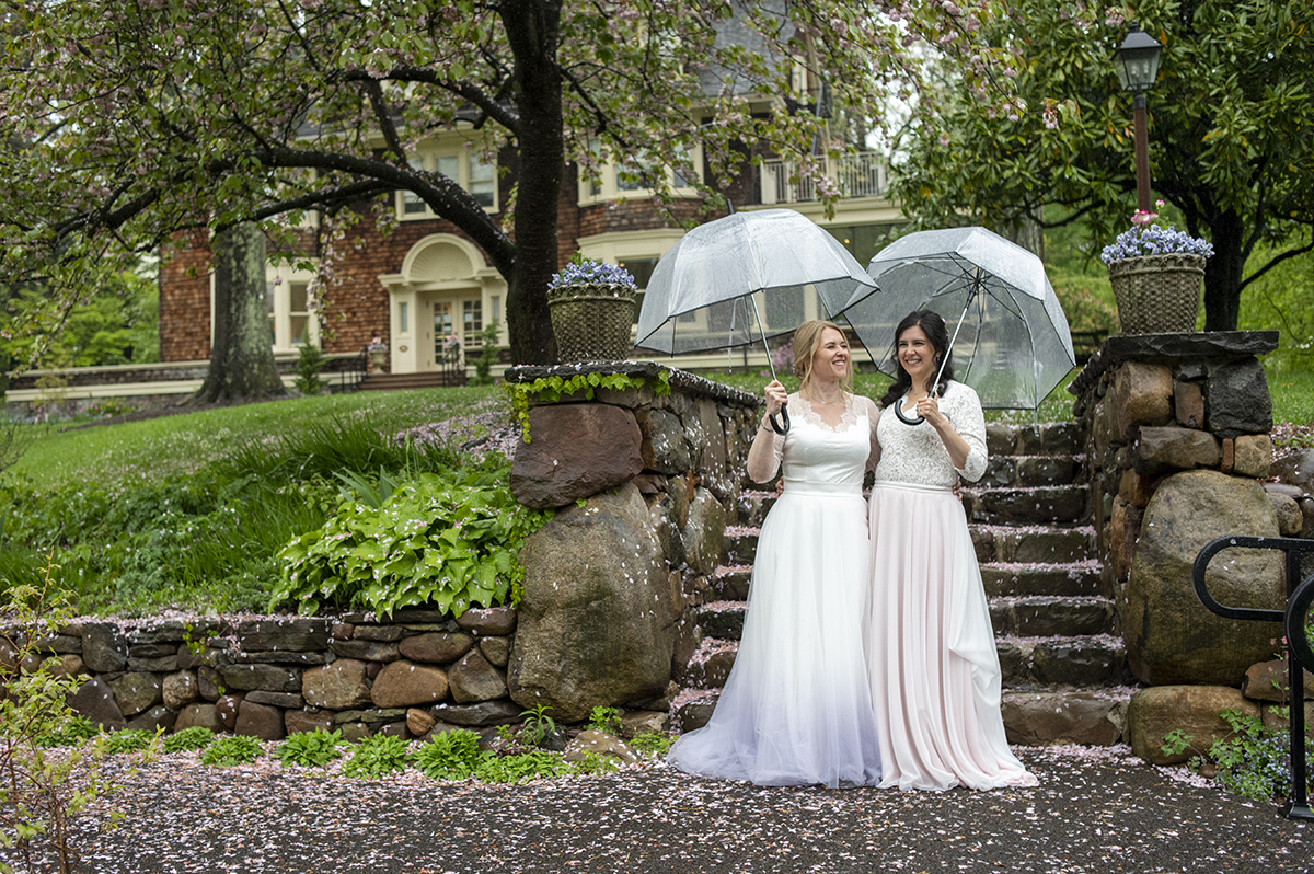 Two brides pose for portraits at Reeves-Reed Arboretum Wedding | LGBTQ wedding photographer