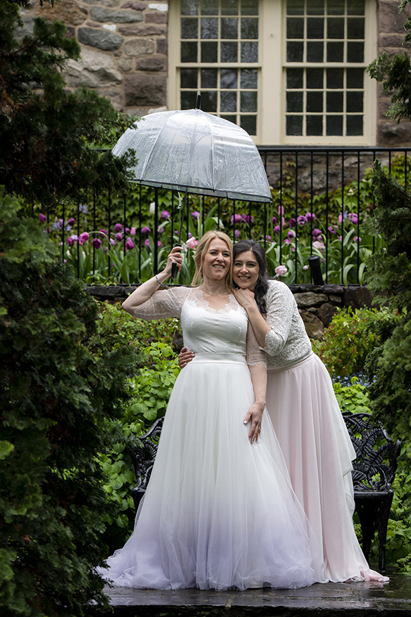 Two brides pose for portraits at Reeves-Reed Arboretum Wedding | LGBTQ wedding photographer