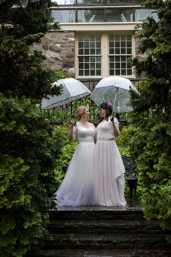 Two brides pose for portraits at Reeves-Reed Arboretum Wedding | LGBTQ wedding photographer