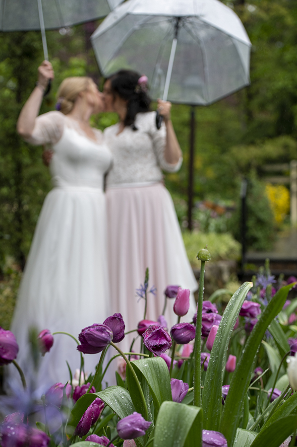 Two brides pose for portraits at Reeves-Reed Arboretum Wedding | LGBTQ wedding photographer