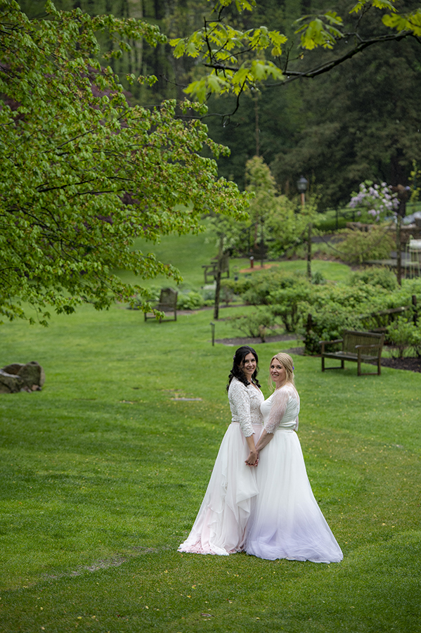 Two brides pose for portraits at Reeves-Reed Arboretum Wedding | LGBTQ wedding photographer