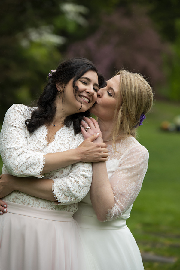 Two brides pose for portraits at Reeves-Reed Arboretum Wedding | LGBTQ wedding photographer