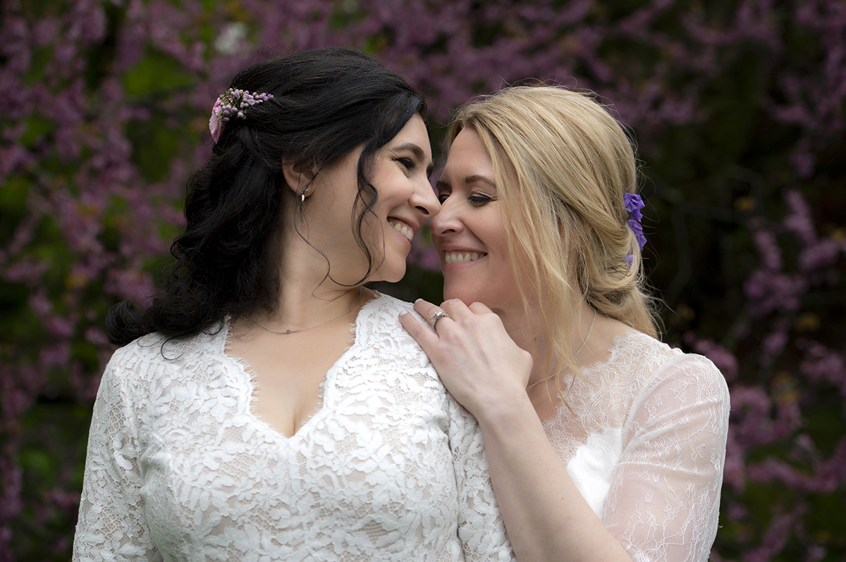 Two brides pose for portraits at Reeves-Reed Arboretum Wedding | LGBTQ wedding photographer
