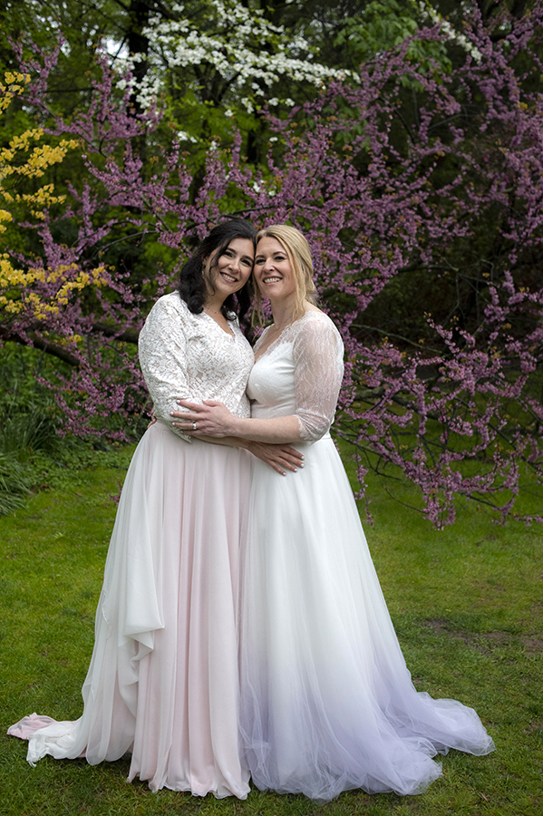 Two brides pose for portraits at Reeves-Reed Arboretum Wedding | LGBTQ wedding photographer