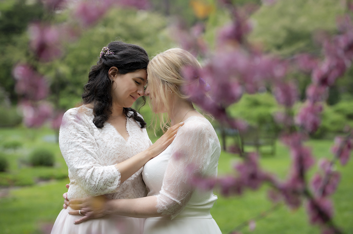 Two brides pose for portraits at Reeves-Reed Arboretum Wedding | LGBTQ wedding photographer