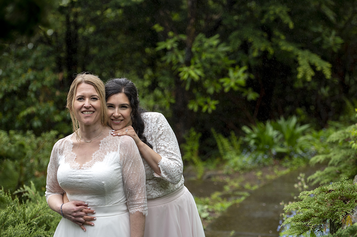 Two brides pose for portraits at Reeves-Reed Arboretum Wedding | LGBTQ wedding photographer