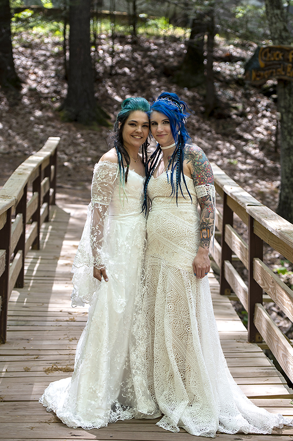 brides in the forest on their wedding day at Riedlbauer’s Resort in the Catskills. LGBTQ wedding
