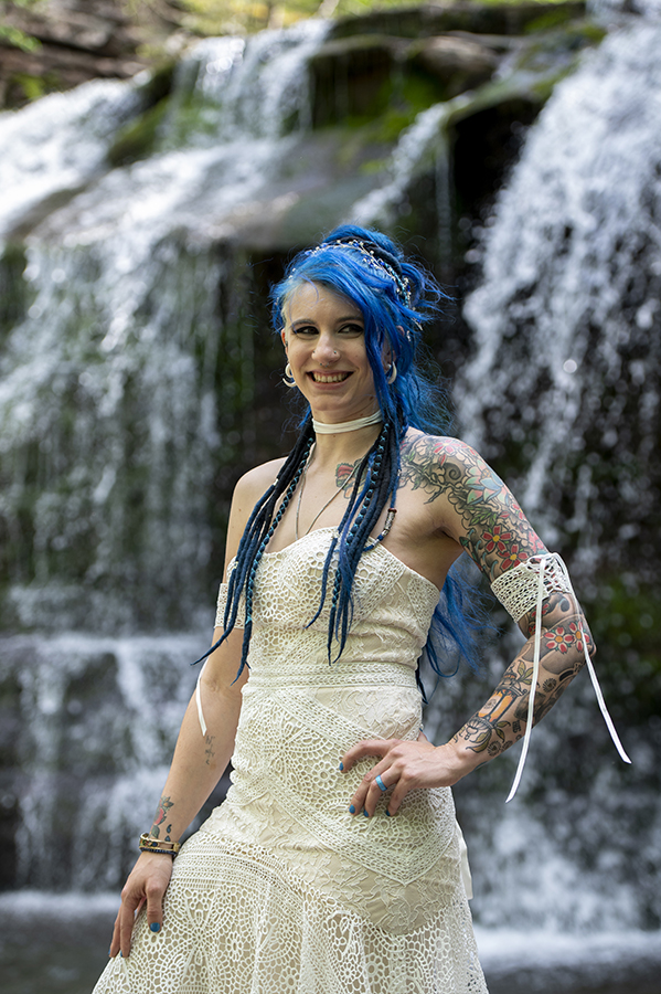 brides at waterfall in the forest on their wedding day at Riedlbauer’s Resort in the Catskills. LGBTQ wedding