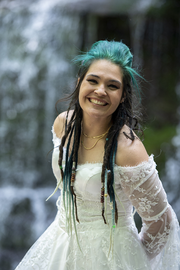brides at waterfall in the forest on their wedding day at Riedlbauer’s Resort in the Catskills. LGBTQ wedding