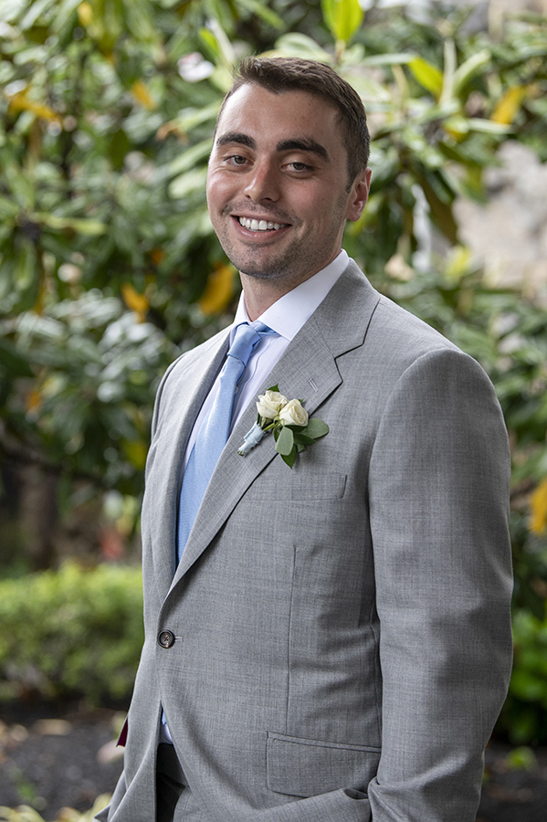 groom pose for portraits on their wedding day at Orienta Beach Club