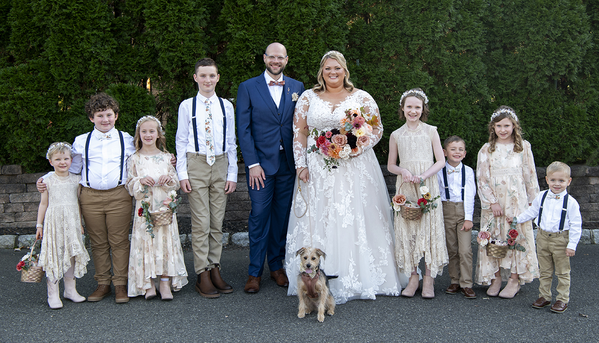 bride and groom with their wedding party at fall wedding at Stone House at Stirling Ridge