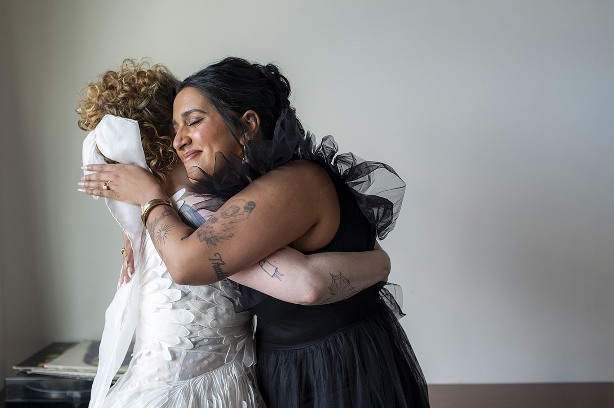 best friend hugs before wedding at Prospect Park Boathouse in Brooklyn