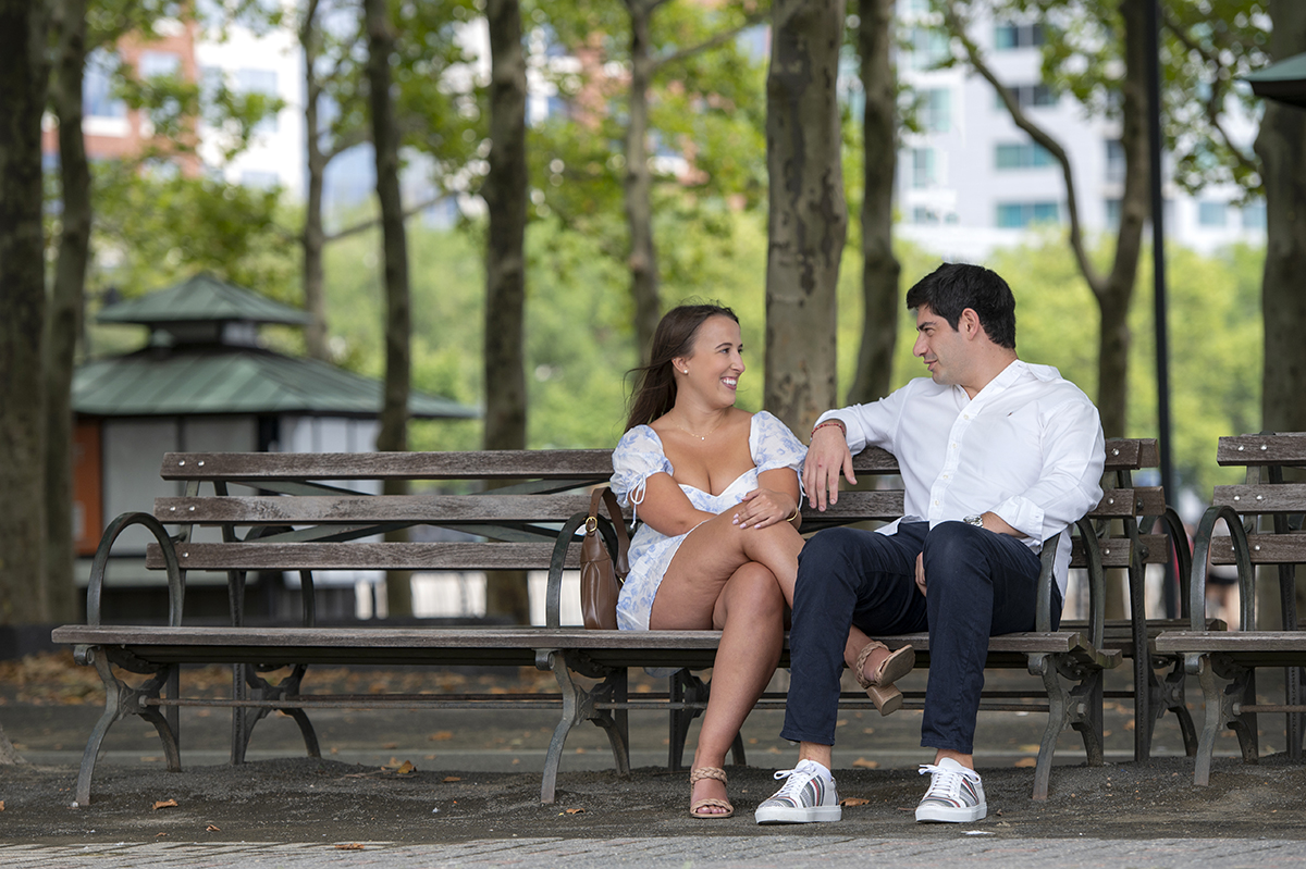 couple posing for portrait after proposal at Pier A in Hoboken