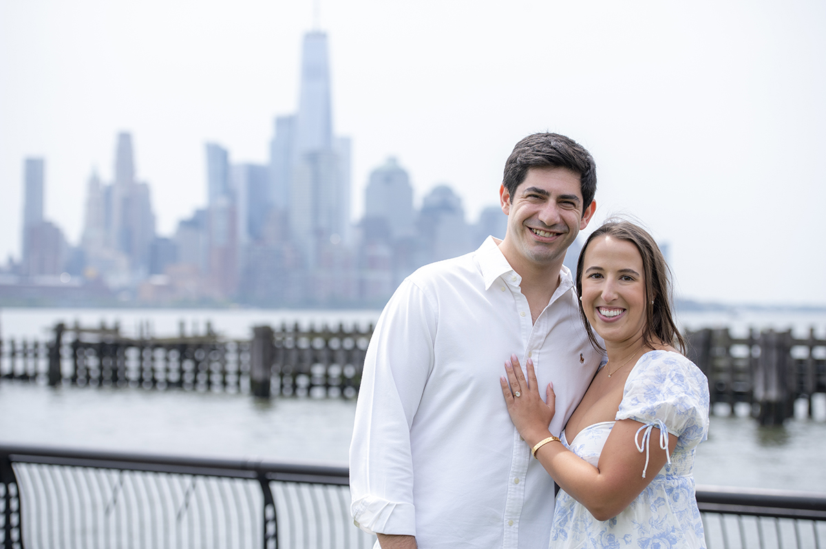 recently engaged couple in Hoboken with NYC skyline