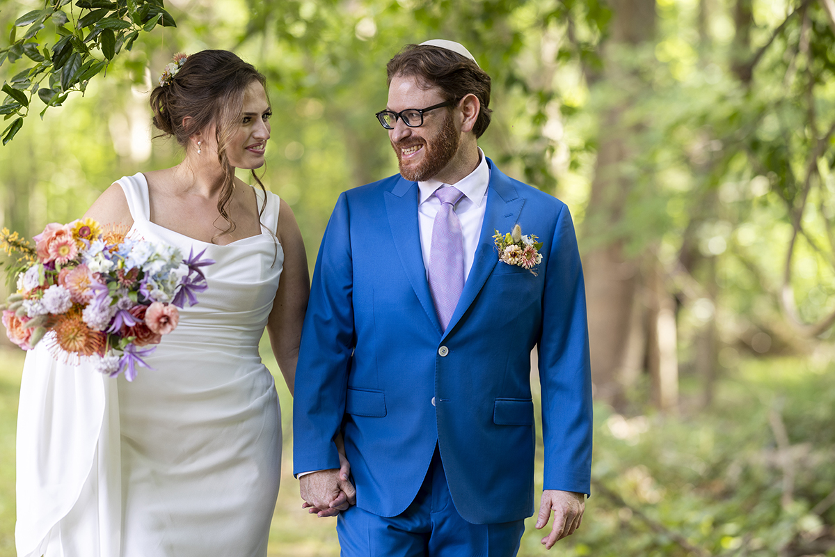 bride and groom walking on their wedding day at Temple Emanu-El Closter