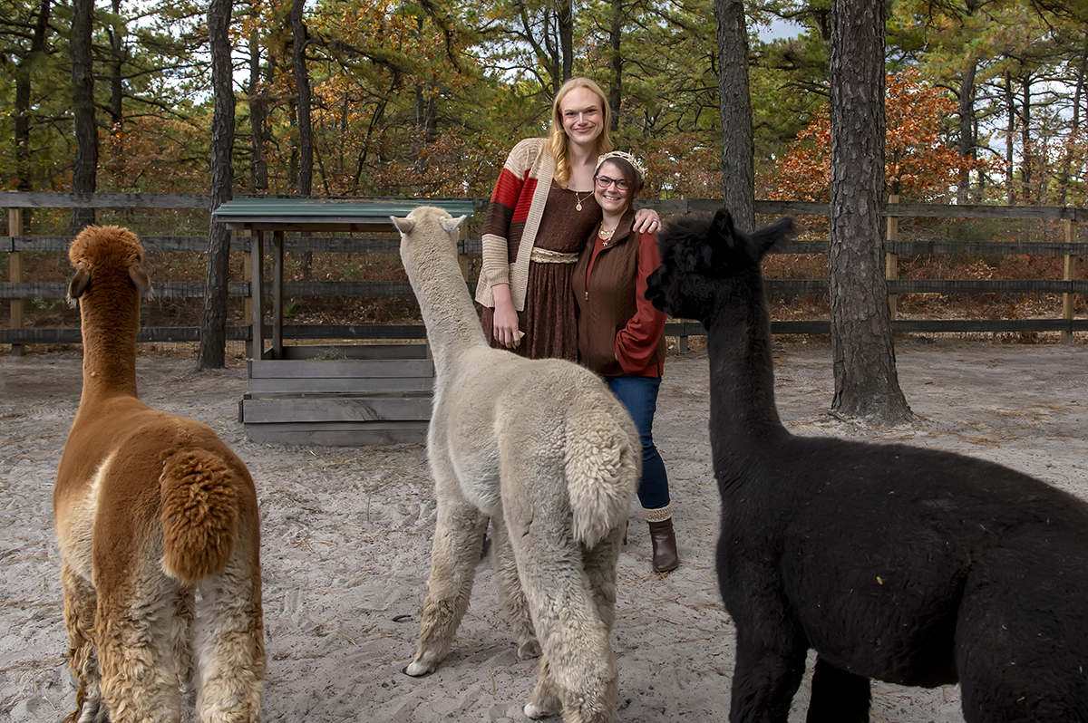 same sex engaged couple at alpaca farm for fall engagement photos