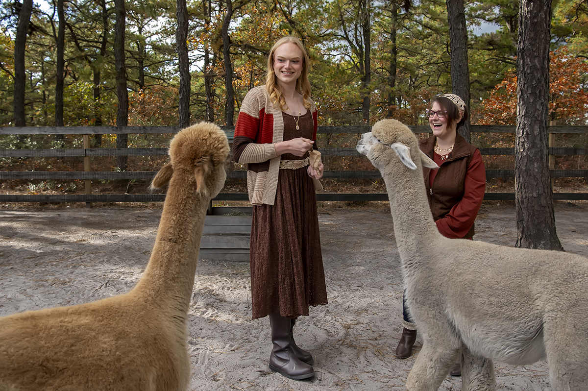 same sex engaged couple at alpaca farm for fall engagement photos