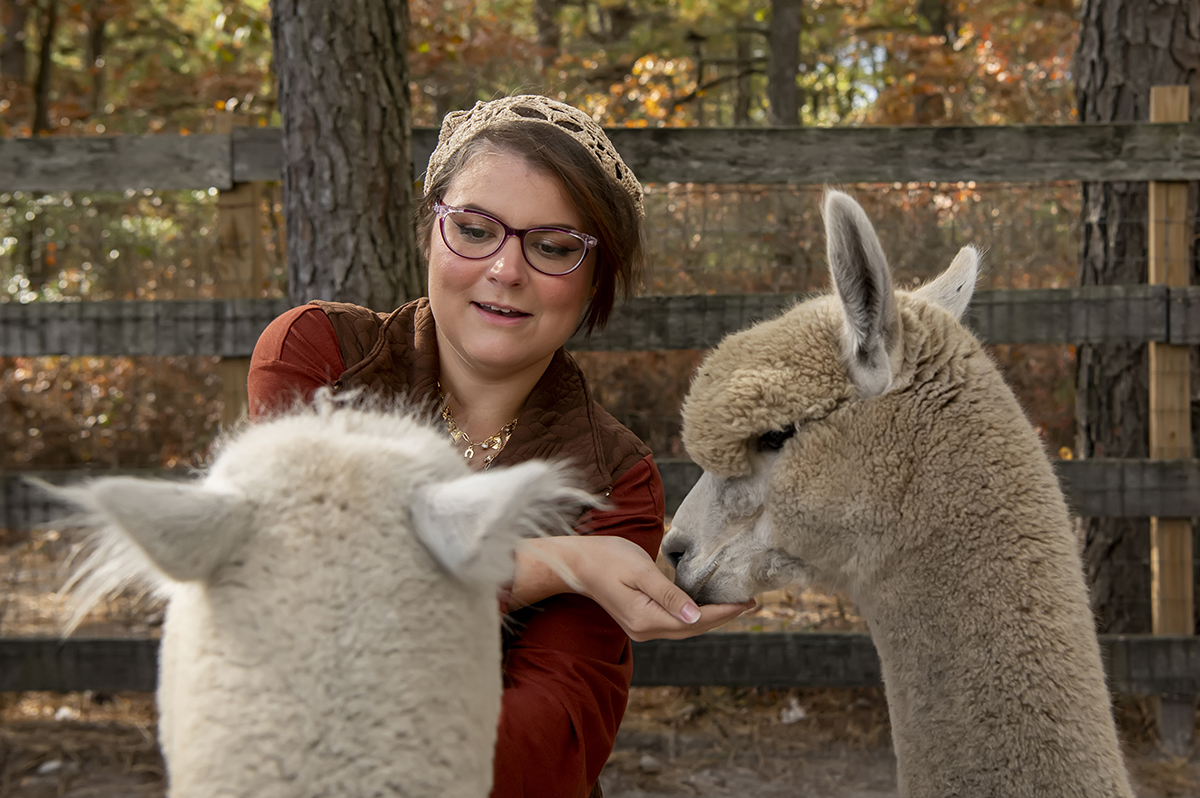 same sex engaged couple at alpaca farm for fall engagement photos