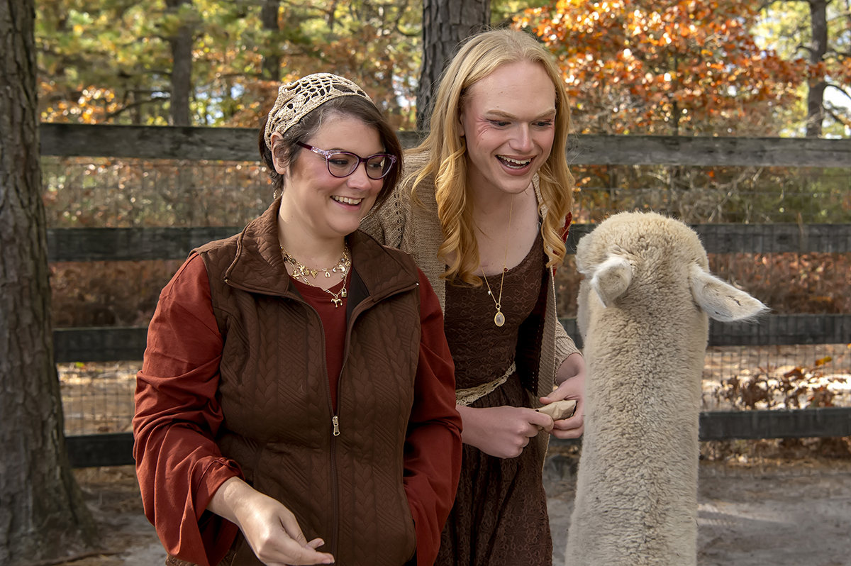 same sex engaged couple at alpaca farm for fall engagement photos