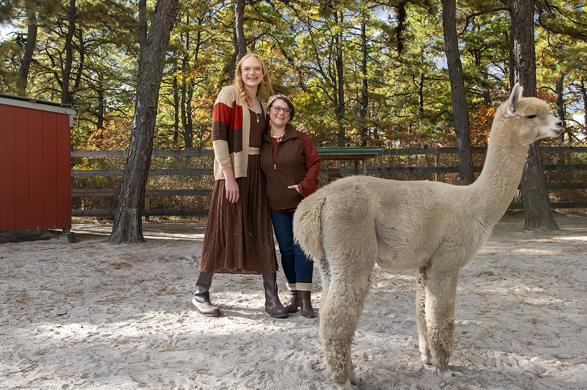 same sex engaged couple at alpaca farm for fall engagement photos